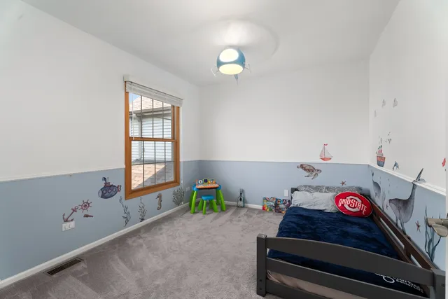 a bed room with a bed and a window