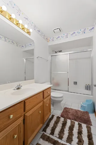 a bedroom with a bed and a mirror on dresser