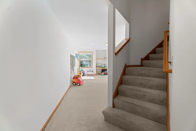 a view of a livingroom with furniture and a large window