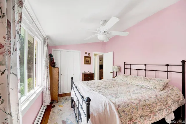 a large bedroom with a large bed and a chandelier