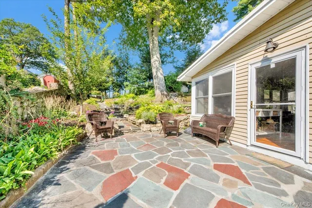 a view of a patio with table and chairs and potted plants