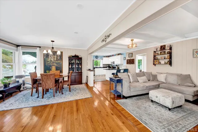 a living room with furniture dining table and a large window