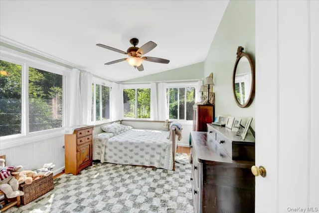a bed room with a bed mirror and a window