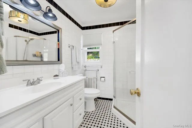 a bathroom with a sink a toilet and a mirror