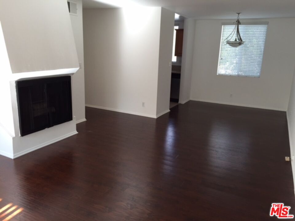 11730 Sunset Boulevard Los Angeles, CA 90049 - Photo 2 of 13 a view of an empty room with wooden floor and a window