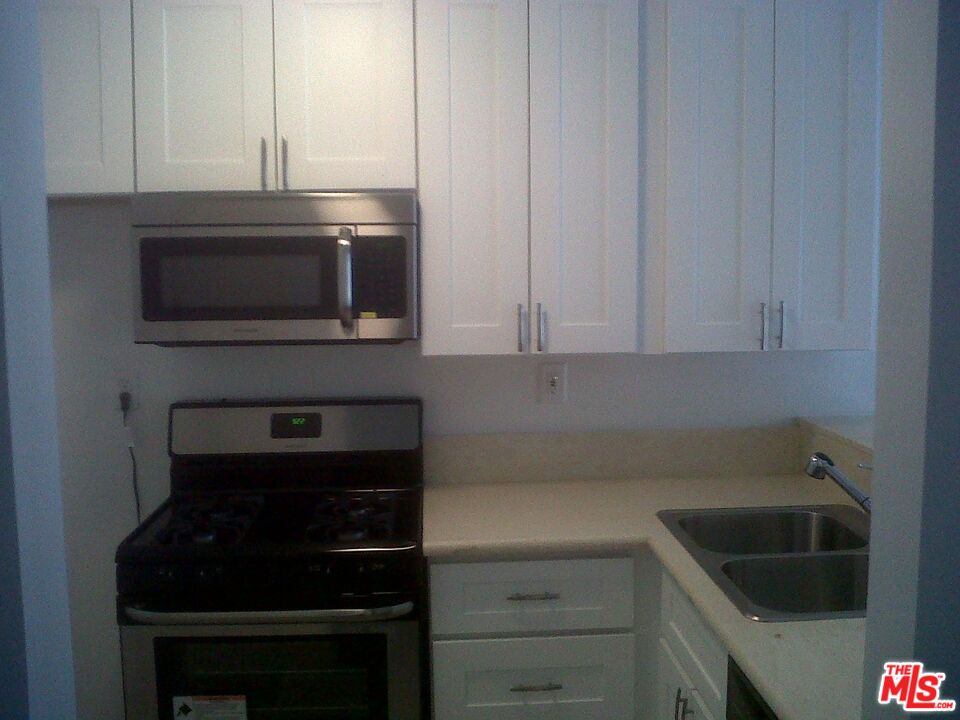 11730 Sunset Boulevard Los Angeles, CA 90049 - Photo 4 of 13 a kitchen with a stove and a microwave