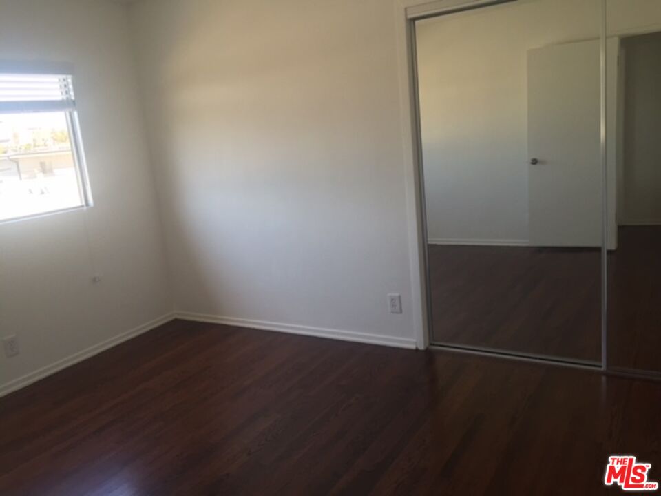 11730 Sunset Boulevard Los Angeles, CA 90049 - Photo 8 of 13 an empty room with wooden floor and windows