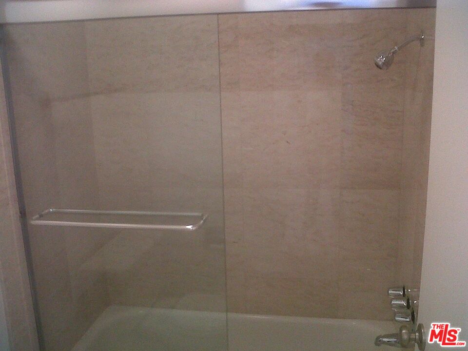 11730 Sunset Boulevard Los Angeles, CA 90049 - Photo 9 of 13 a bathroom with a glass shower door