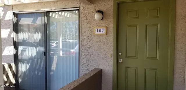 a bathroom with a glass door shower and a sink