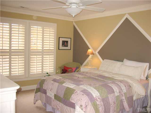 8214 Lloyd Allyns Way Raleigh, NC 27615 - Photo 11 of 16 Special millwork accents are evident in this secondary bedroom with unique beadboard trim.
