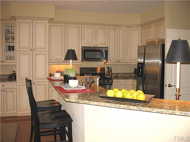 The kitchen boasts granite countertops, stainless steel appliances and a gas range.
