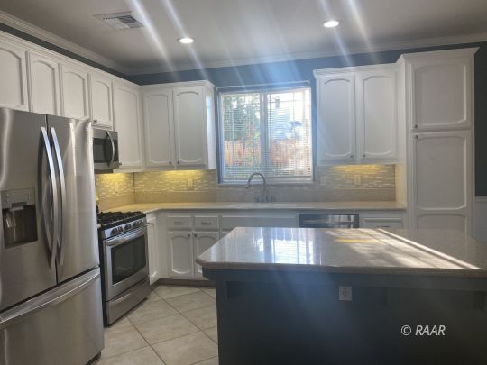 1120 Boston Ridgecrest, CA 93555 - Photo 4 of 10 a kitchen with granite countertop a refrigerator and a sink