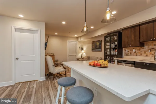 a kitchen with stainless steel appliances granite countertop a sink and a refrigerator
