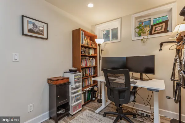 a view of a workspace with furniture and a window