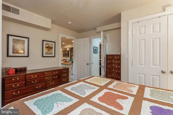 a bedroom with a bed and a dresser