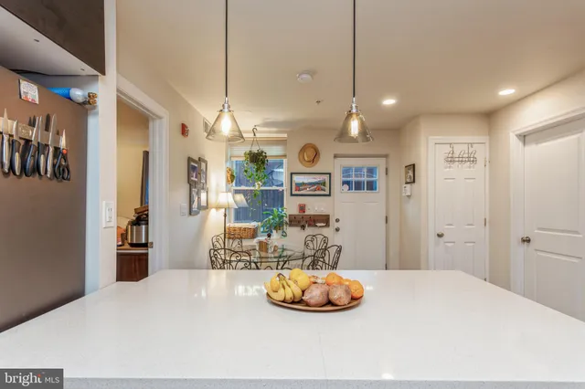 a kitchen with stainless steel appliances a refrigerator sink and cabinets