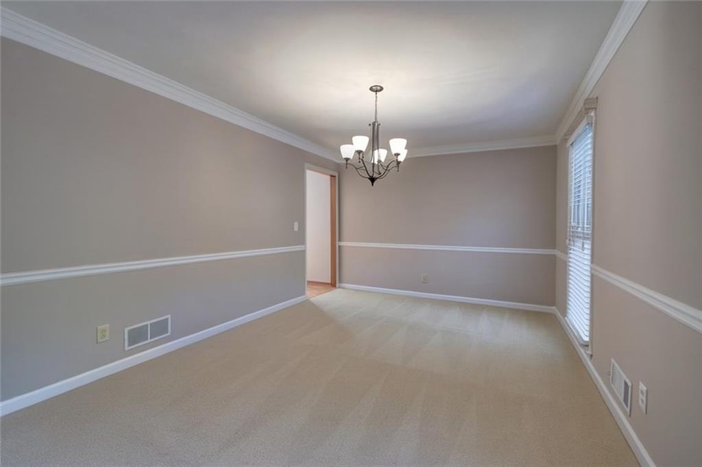 260 Spring Ridge Drive Roswell, GA 30076 - Photo 11 of 52 an empty room with a chandelier fan