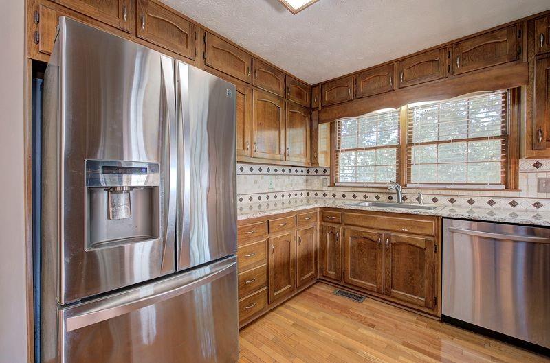 260 Spring Ridge Drive Roswell, GA 30076 - Photo 16 of 52 a kitchen with stainless steel appliances granite countertop a refrigerator and a sink