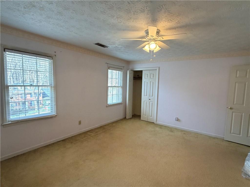 260 Spring Ridge Drive Roswell, GA 30076 - Photo 29 of 52 an empty room with windows and fan