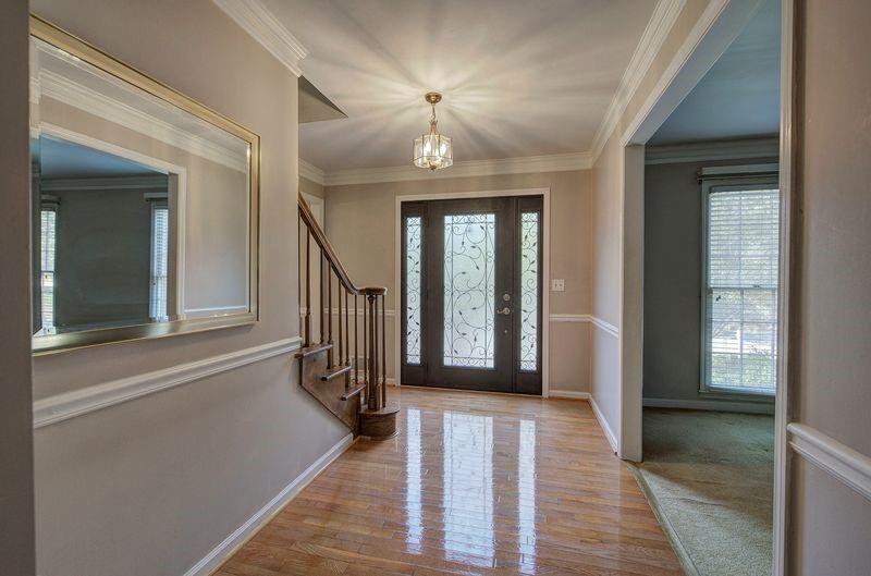 260 Spring Ridge Drive Roswell, GA 30076 - Photo 3 of 52 a view of a hallway with wooden floor and staircase