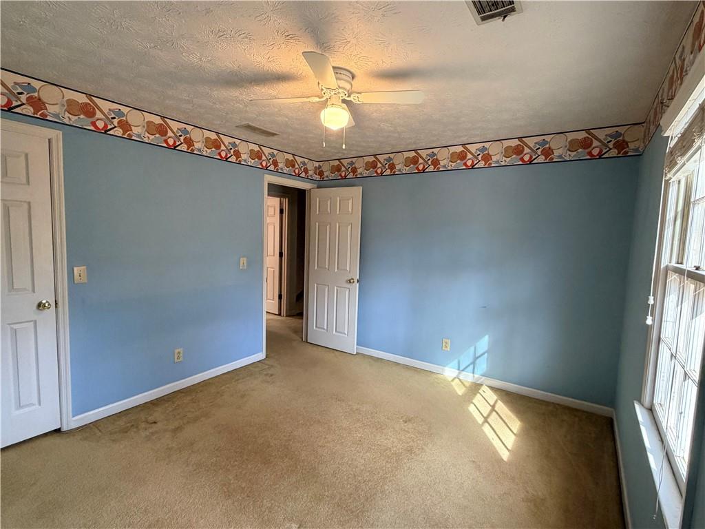 260 Spring Ridge Drive Roswell, GA 30076 - Photo 32 of 52 an empty room with a ceiling fan and carpet
