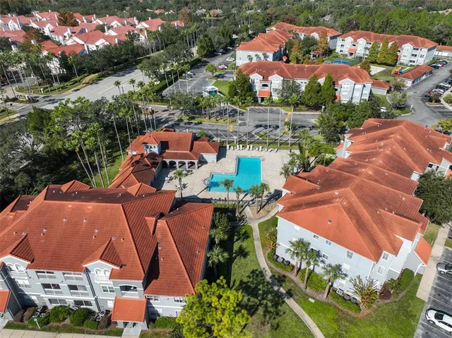 an aerial view of a house with a garden and lake view