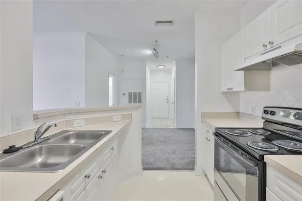 a kitchen that has a sink and a stove