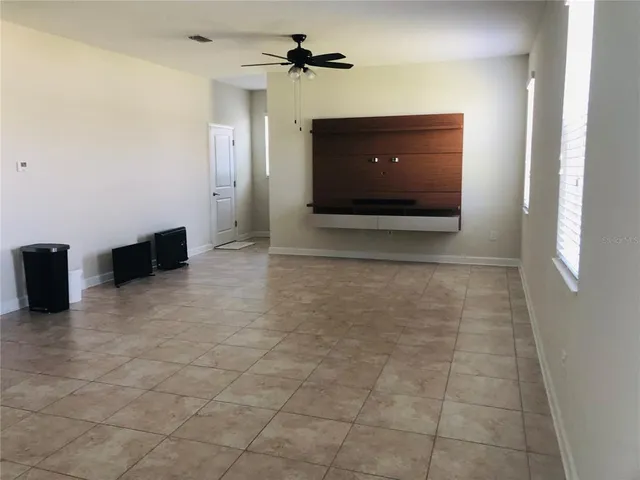 a kitchen with kitchen island granite countertop wooden cabinets a refrigerator and a sink