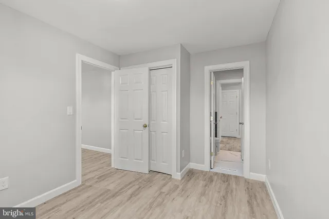 a view of an empty room and wooden floor