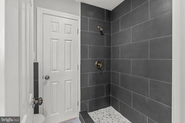 a bathroom with a glass shower door