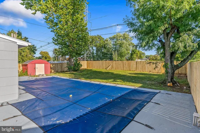 a swimming pool with the trees in the background