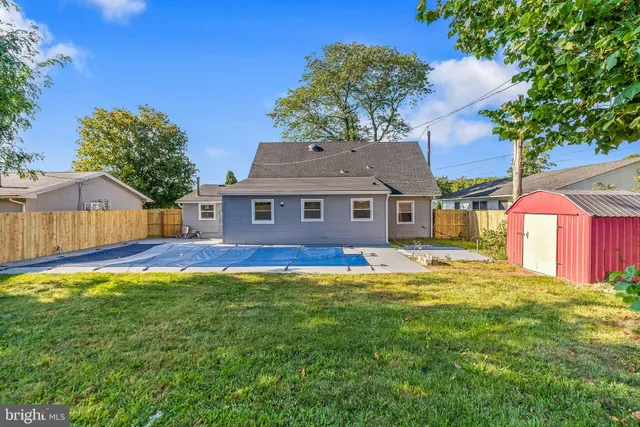 a view of a backyard with wooden fence