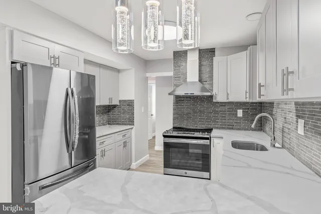 a kitchen with stainless steel appliances a refrigerator sink and cabinets