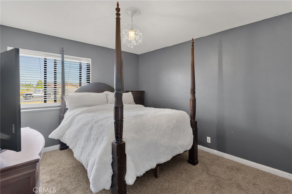 20357 Ituma Road Apple Valley, CA 92308 - Photo 17 of 38 a bedroom with a bed and window