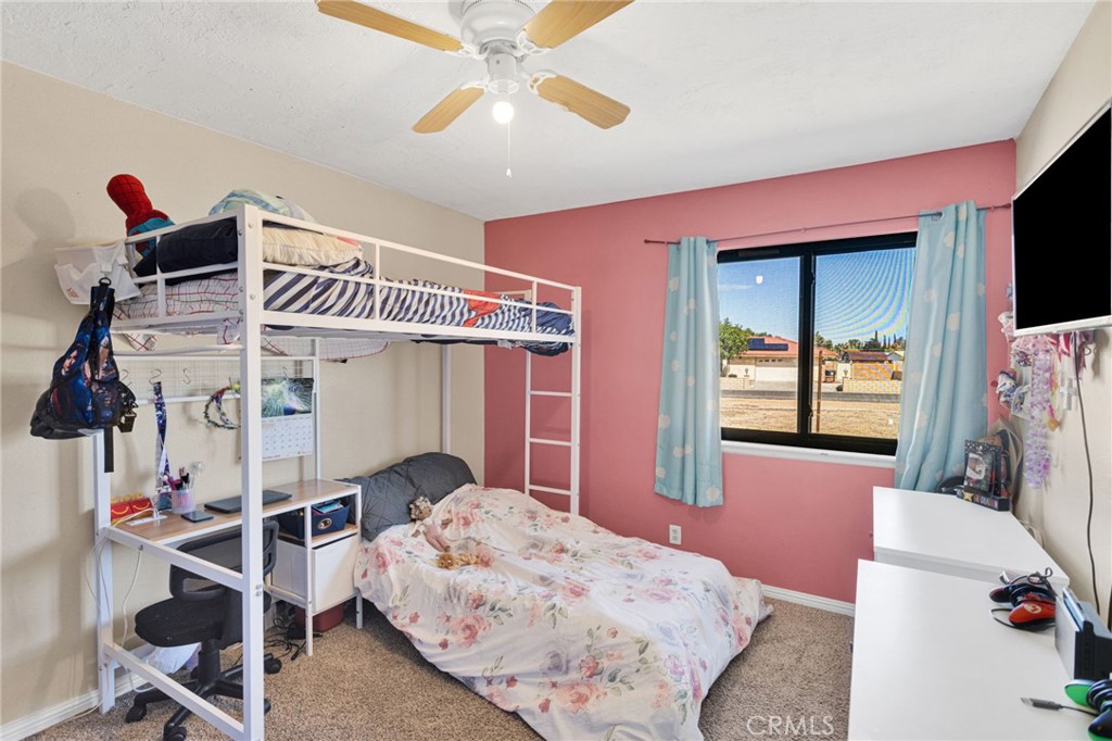 20357 Ituma Road Apple Valley, CA 92308 - Photo 20 of 38 a bedroom with a bed and a window