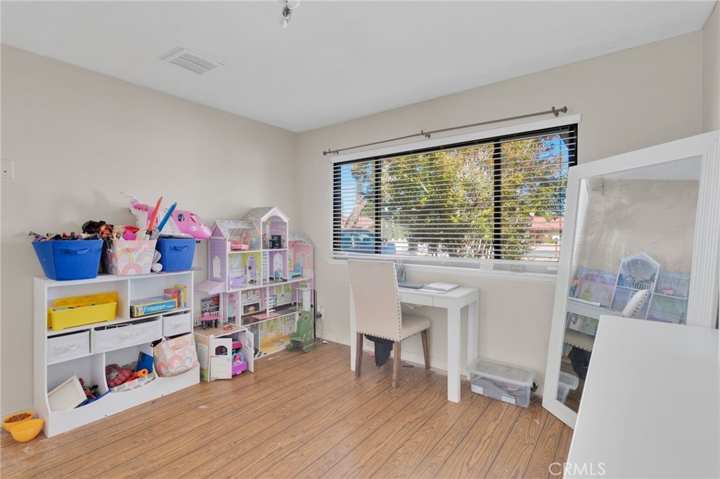 20357 Ituma Road Apple Valley, CA 92308 - Photo 23 of 38 a bedroom with furniture and a wooden floor
