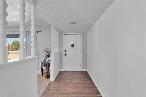 a view of a patio with a table and chairs