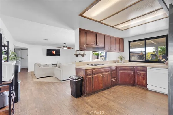 a kitchen with stainless steel appliances granite countertop a stove a sink dishwasher and a refrigerator
