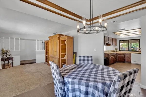 a bedroom with a bed a dresser and flat screen tv