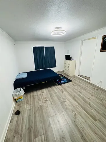 a bedroom with a bed and a dresser