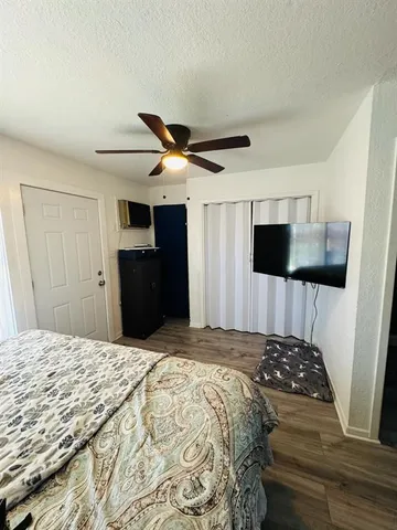 a bedroom with a bed and a flat tv screen