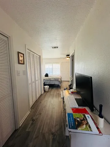 a bedroom with furniture and a wooden floor