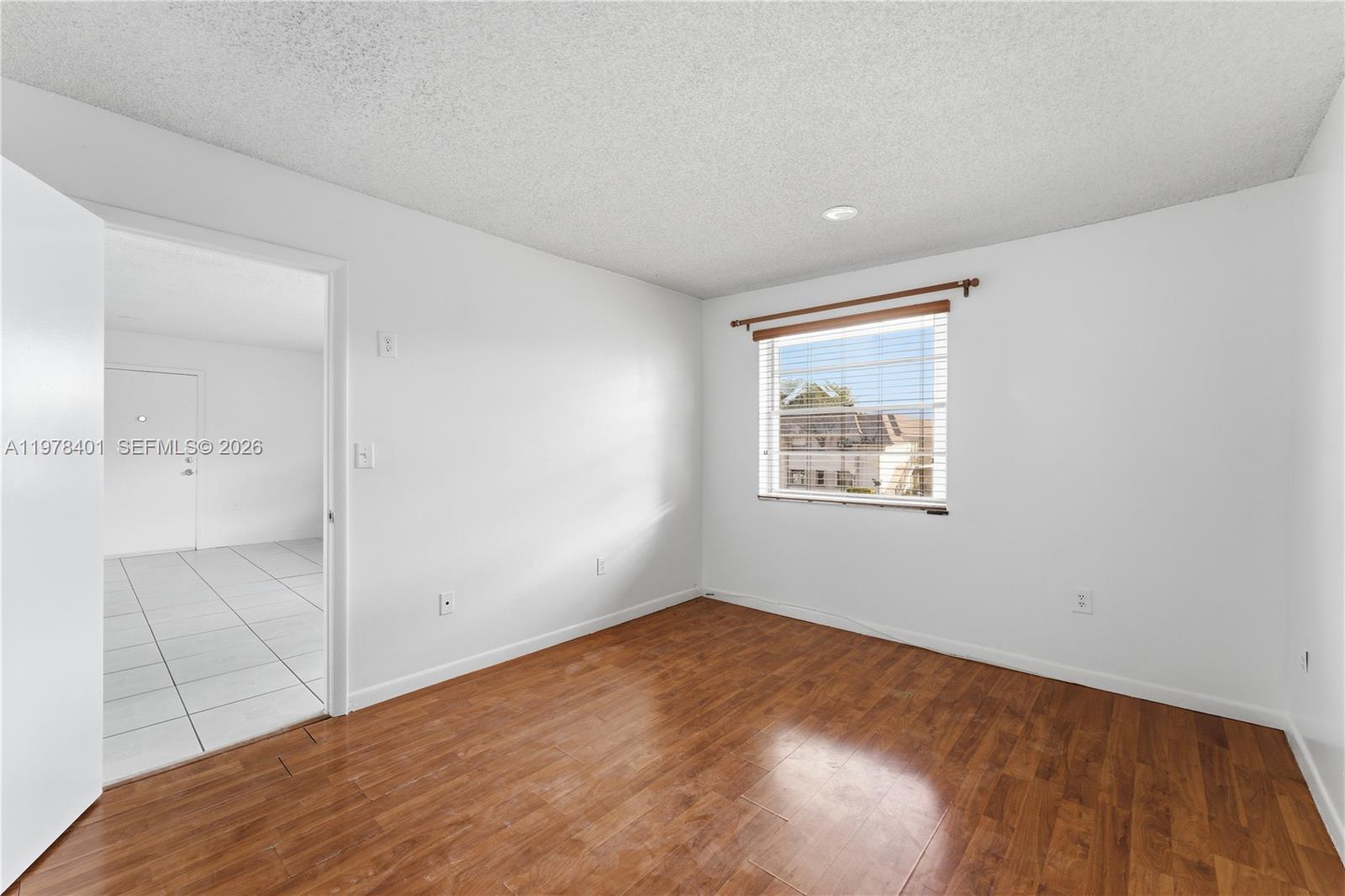 6921 Southwest 129th Avenue, Unit 5 Miami, FL 33183 - Photo 11 of 34 an empty room with a window