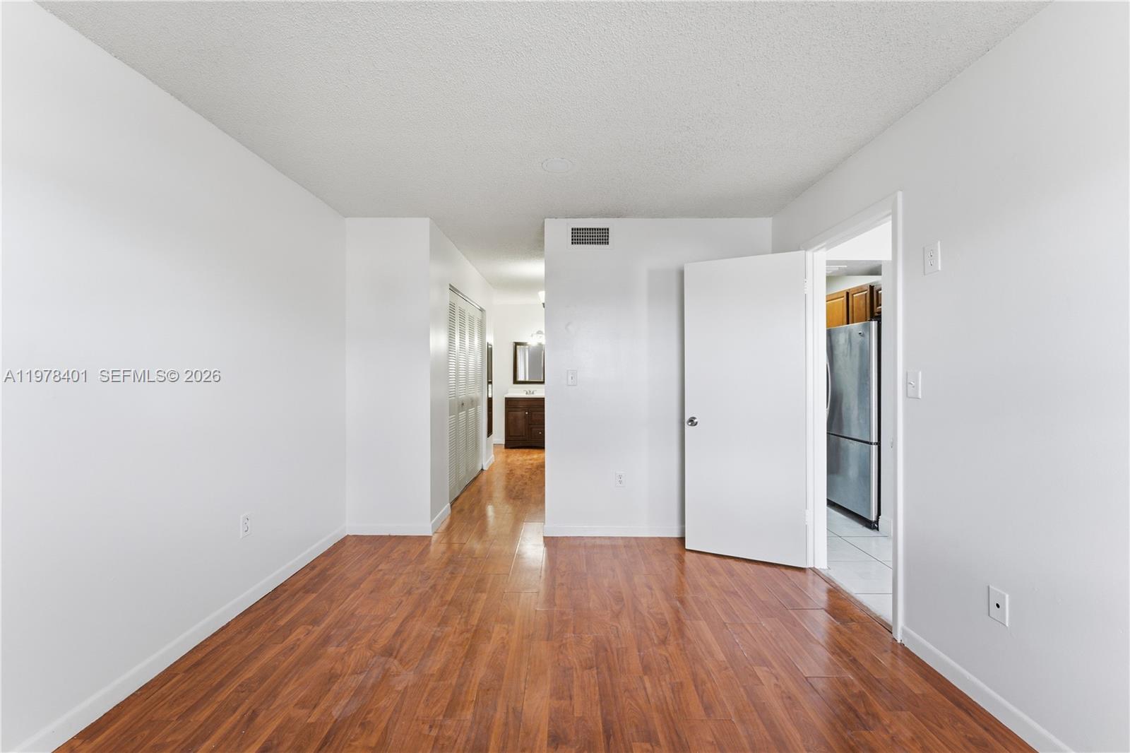 6921 Southwest 129th Avenue, Unit 5 Miami, FL 33183 - Photo 12 of 34 a view of empty room with wooden floor