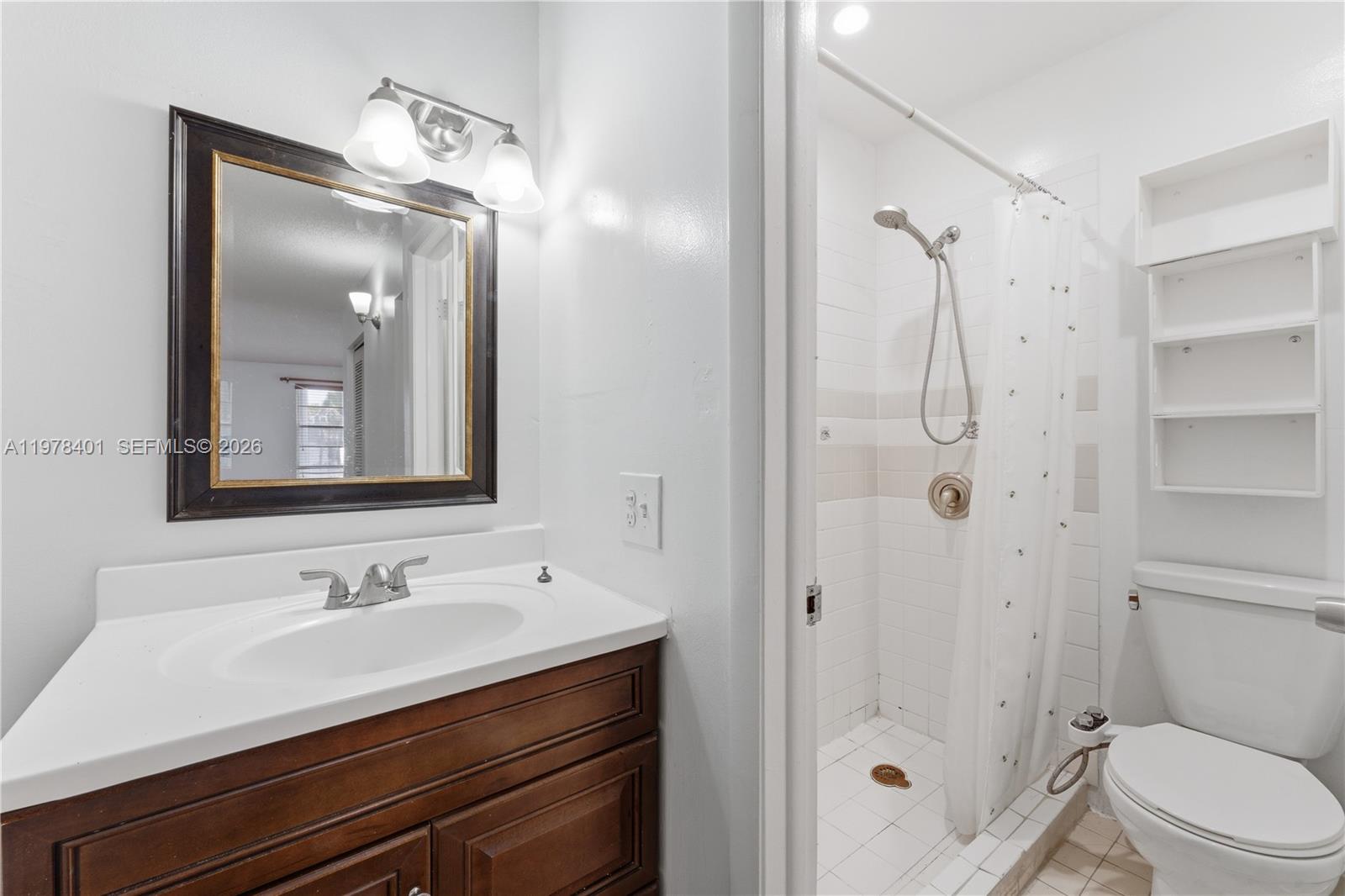 6921 Southwest 129th Avenue, Unit 5 Miami, FL 33183 - Photo 13 of 34 a bathroom with a sink a toilet and shower