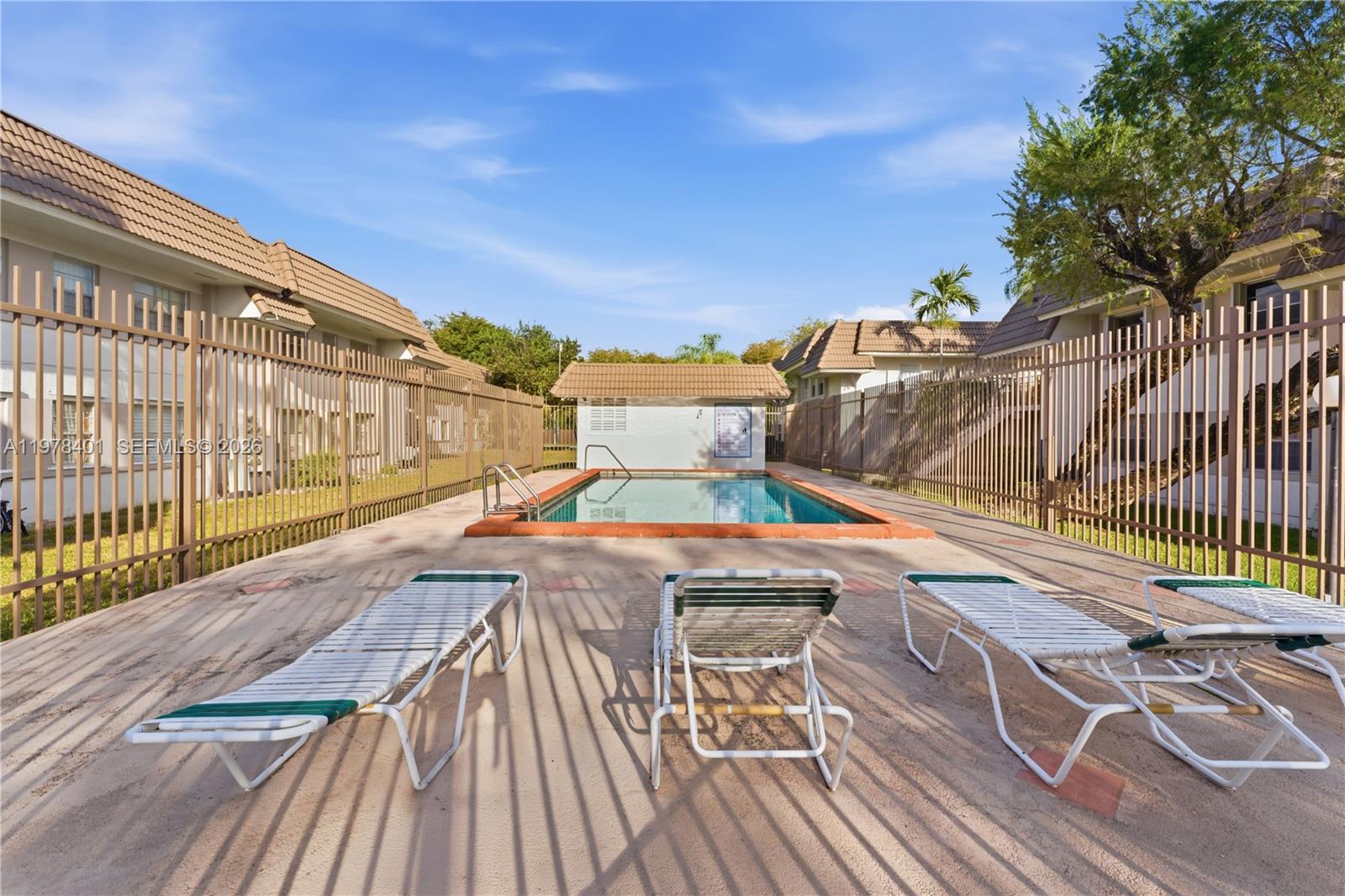 6921 Southwest 129th Avenue, Unit 5 Miami, FL 33183 - Photo 16 of 34 a view of balcony with wooden floor and outdoor seating
