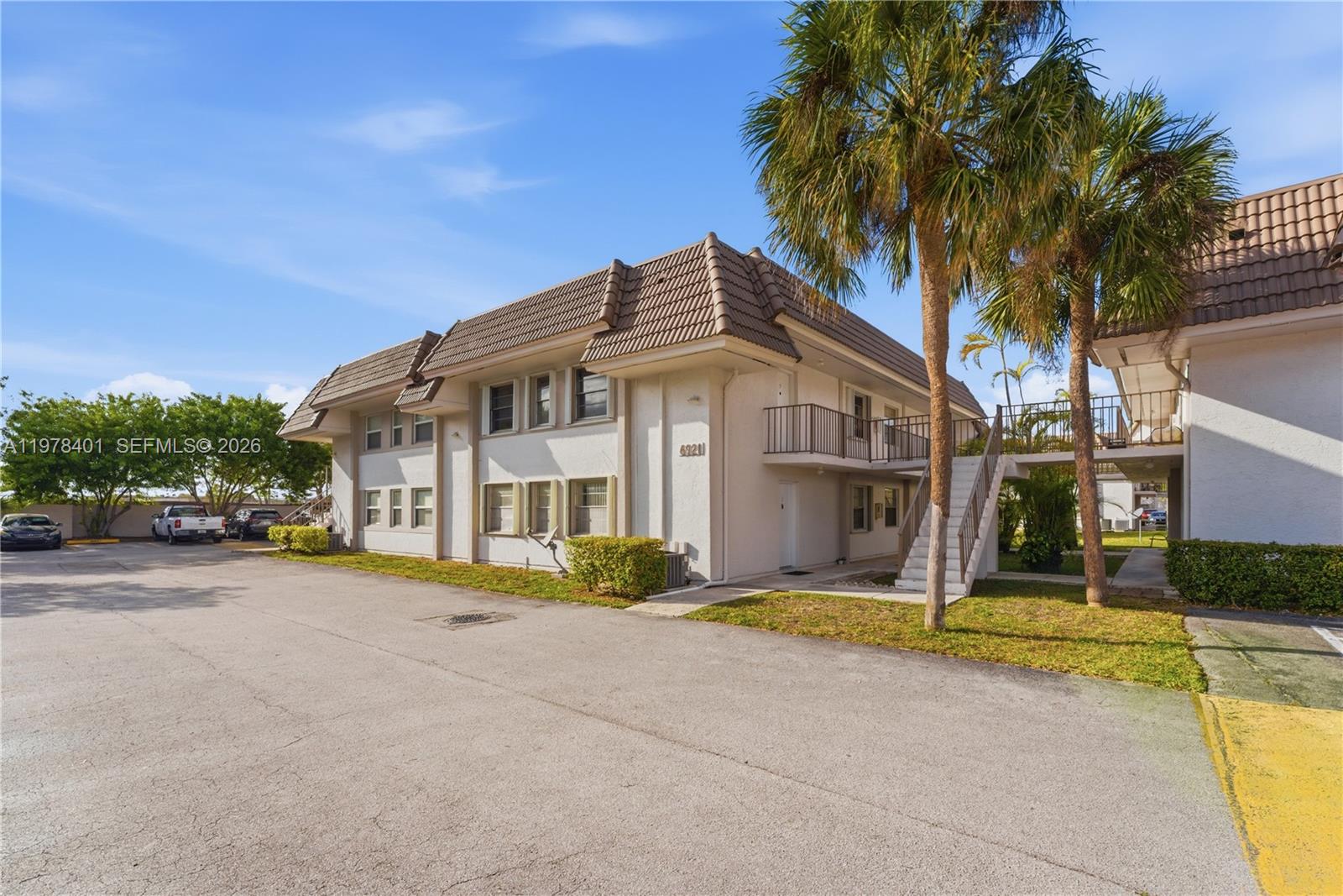 6921 Southwest 129th Avenue, Unit 5 Miami, FL 33183 - Photo 24 of 34 a front view of house with yard and green space