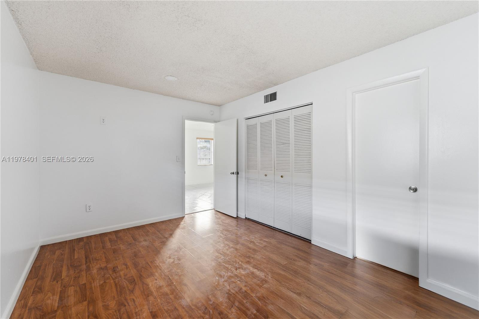 6921 Southwest 129th Avenue, Unit 5 Miami, FL 33183 - Photo 29 of 34 a view of an empty room with wooden floor