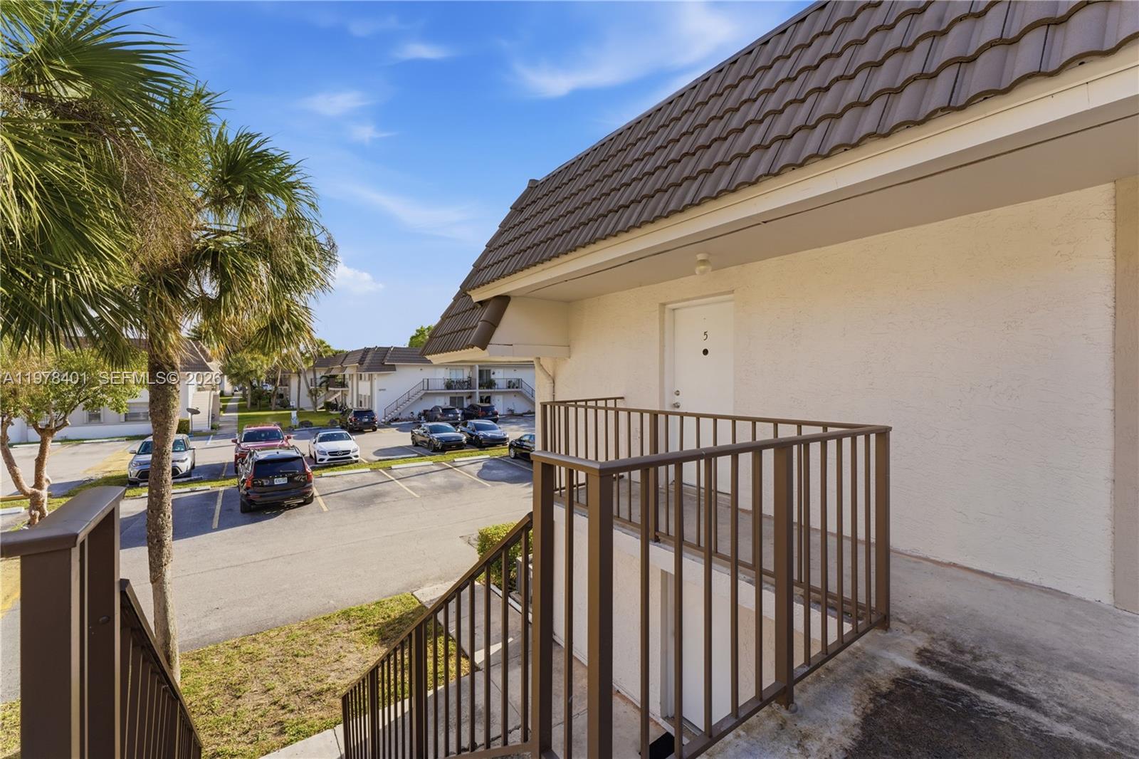 6921 Southwest 129th Avenue, Unit 5 Miami, FL 33183 - Photo 4 of 34 a view of balcony and car parked