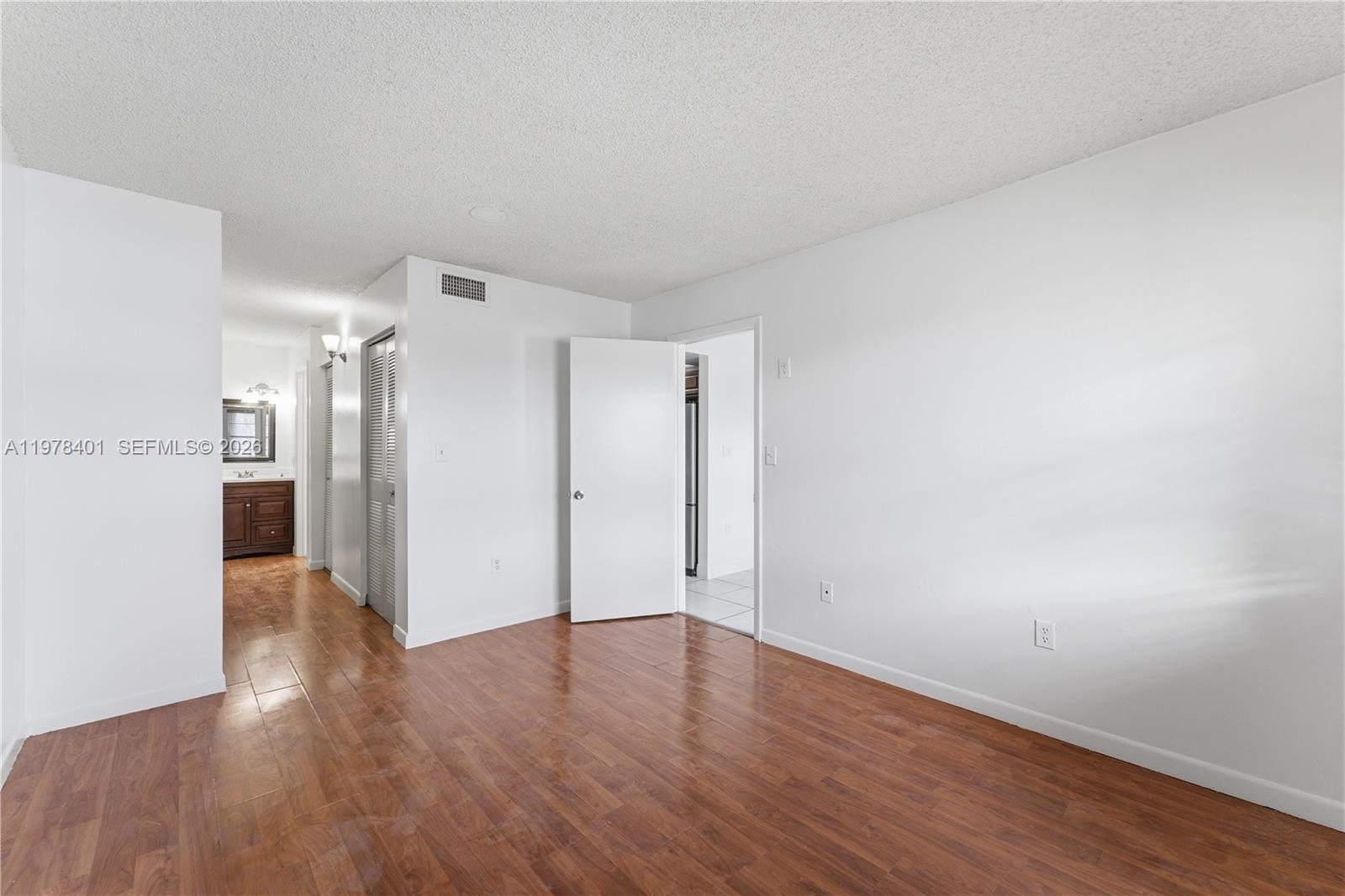 6921 Southwest 129th Avenue, Unit 5 Miami, FL 33183 - Photo 5 of 34 a view of a big room with wooden floor